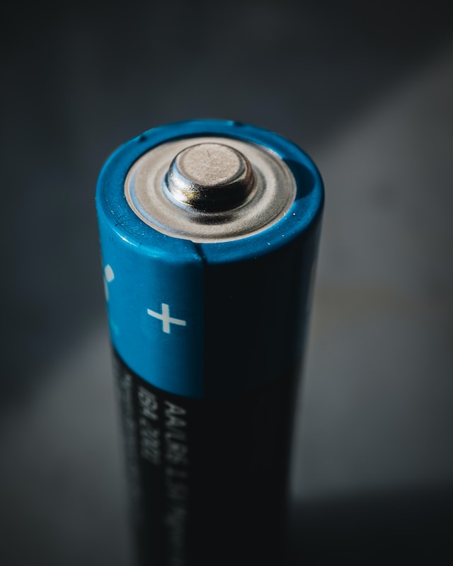 A blue and black double A battery. Photo by Mika Baumeister on Unsplash