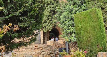 Outer wall of Alcazaba fortress Malaga Spain. A lot of trees and plants can be seen across.