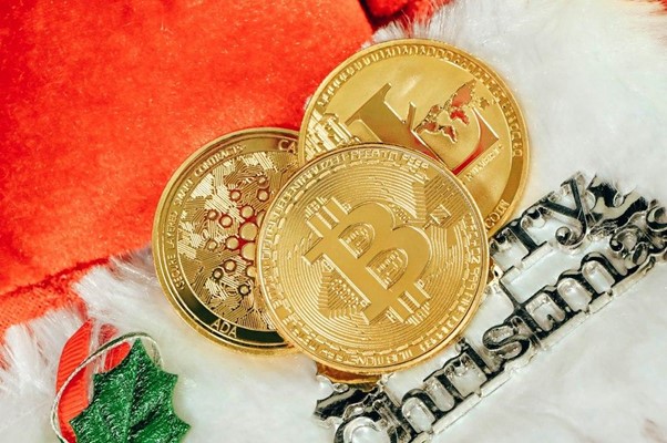 Three golden bitcoins on a white and orange background.