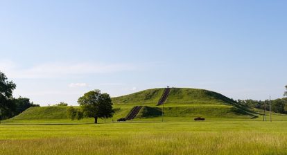 Monks Mound is the largest earthen structure at Cahokia (for scale, people below and on top). About 80 earthen mounds or earthworks survive at the archeology site out of perhaps as many as 120 at the city's apex.