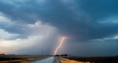 An empty road with lightening and heavy clouds