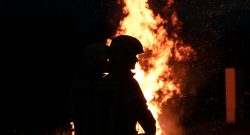 silhouette of a fire fighter in front of a fire